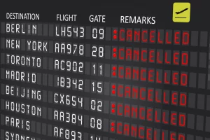 Airport departure board displaying cancelled flights during travel disruption